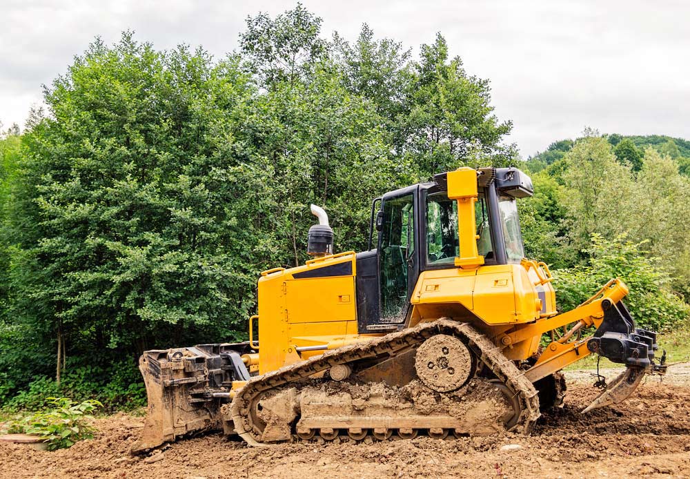 Small Bulldozer Covered in Mud — Tree Removal & Land Clearing in Kariong, NSW